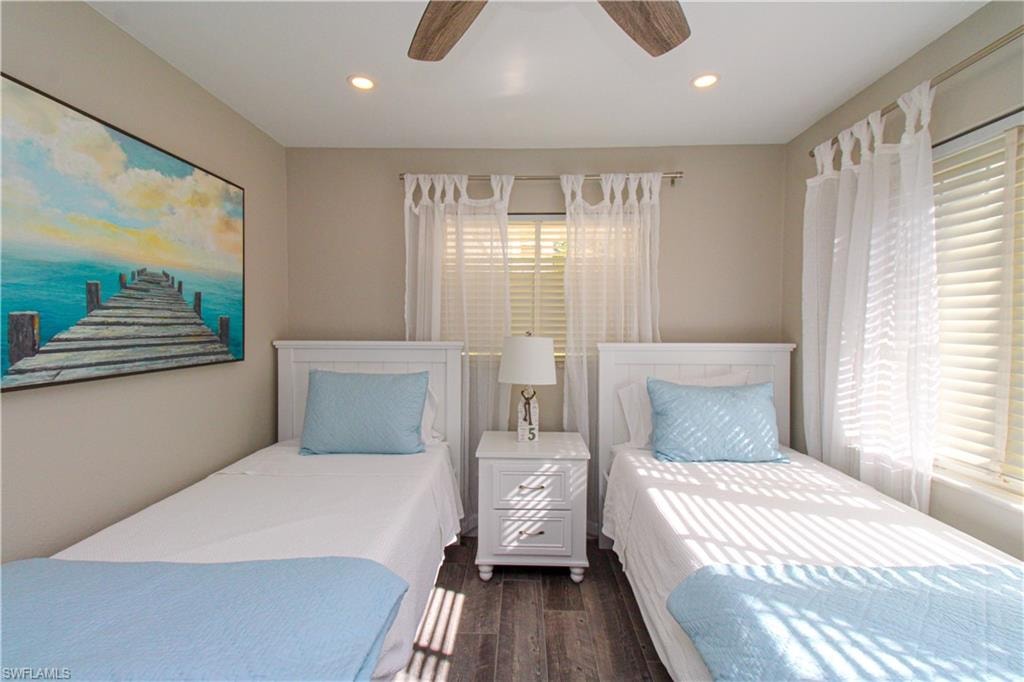 Bedroom featuring ceiling fan and dark wood-type flooring