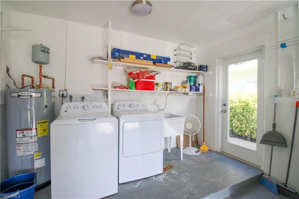 Washroom featuring washing machine and dryer and electric water heater