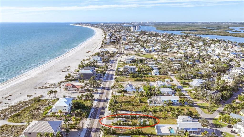 Aerial perspective of suburban area featuring waterfront with a beach