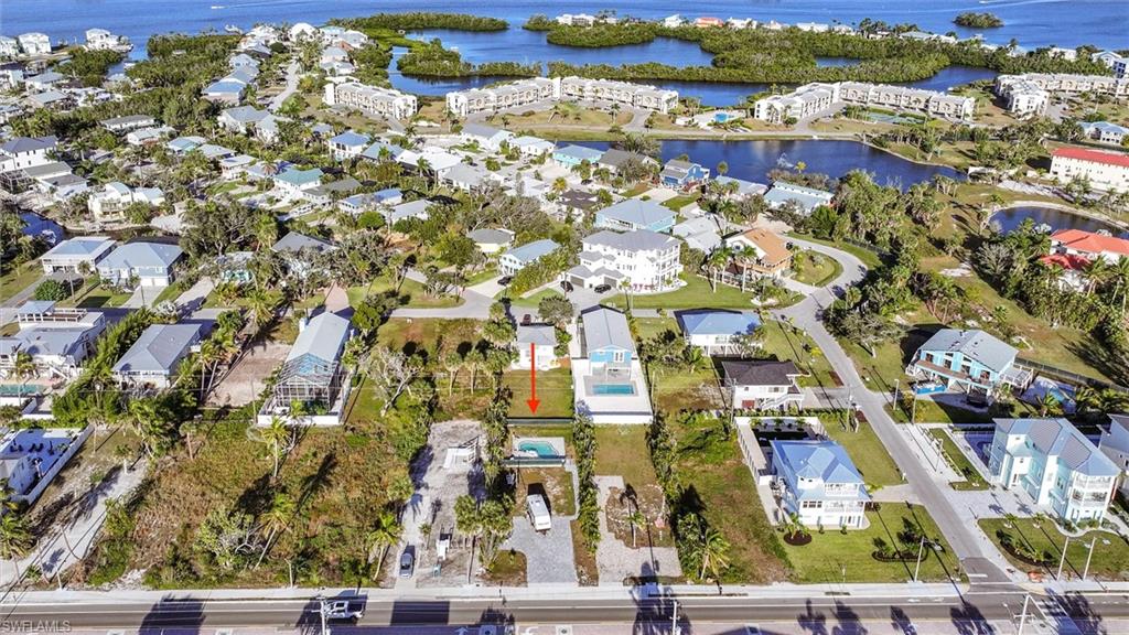 View of property location with a large body of water and nearby suburban area