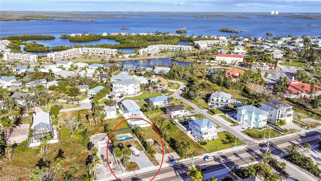 Aerial perspective of suburban area featuring a large body of water