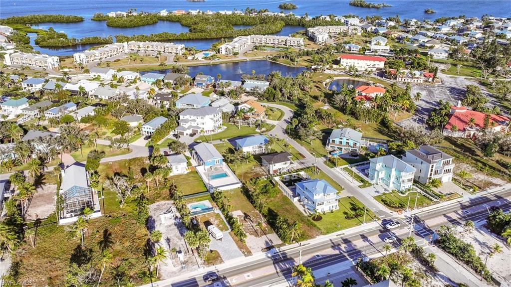Aerial overview of property's location with nearby suburban area and a nearby body of water
