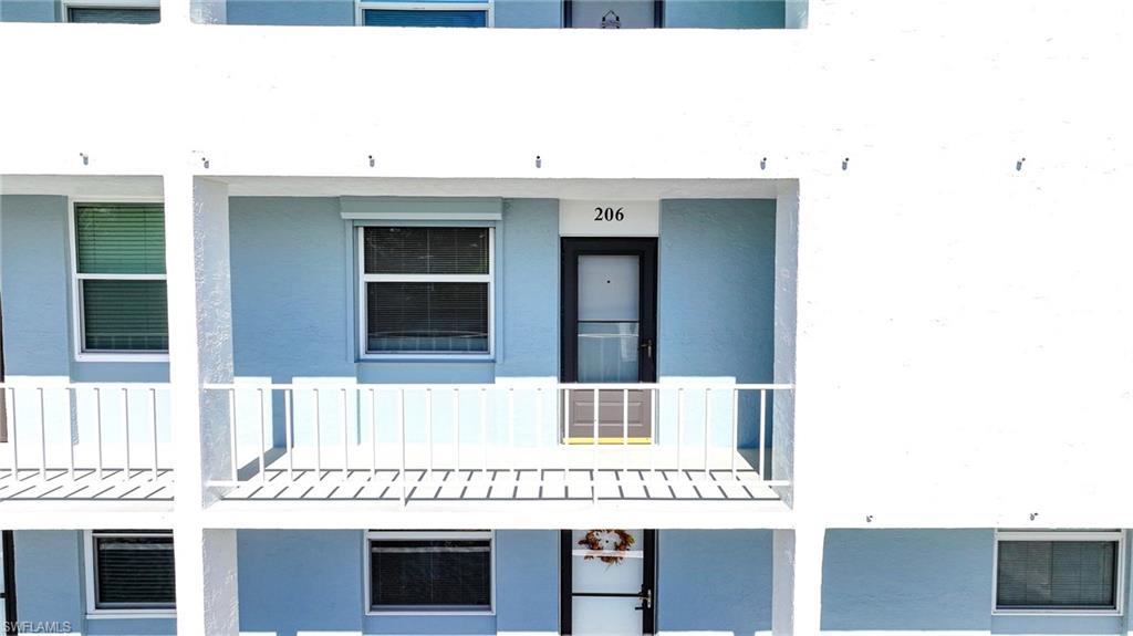 Aerial View Of Balcony And Front Door And Window With Shutters!