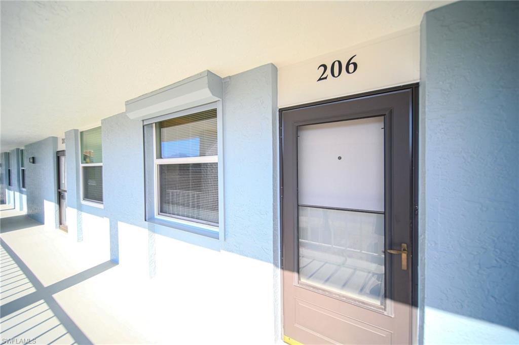 Front Entry Into Unit With Storm Shutters Over Window!