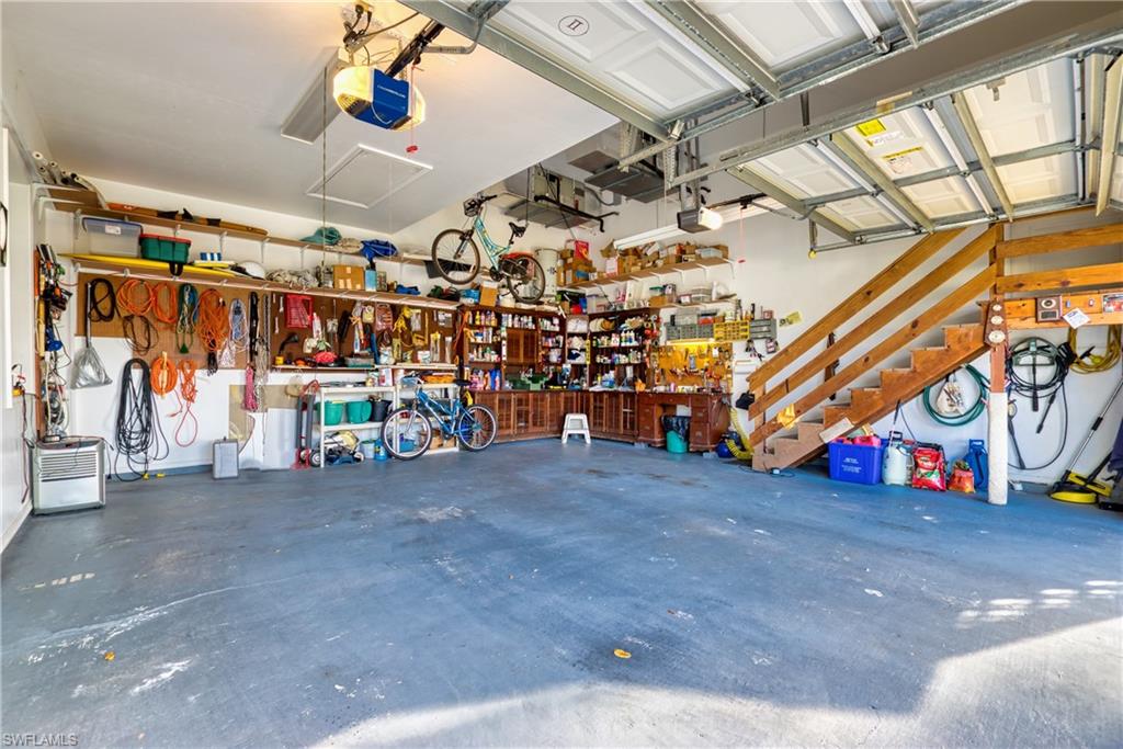 Garage featuring a workshop area and a garage door opener