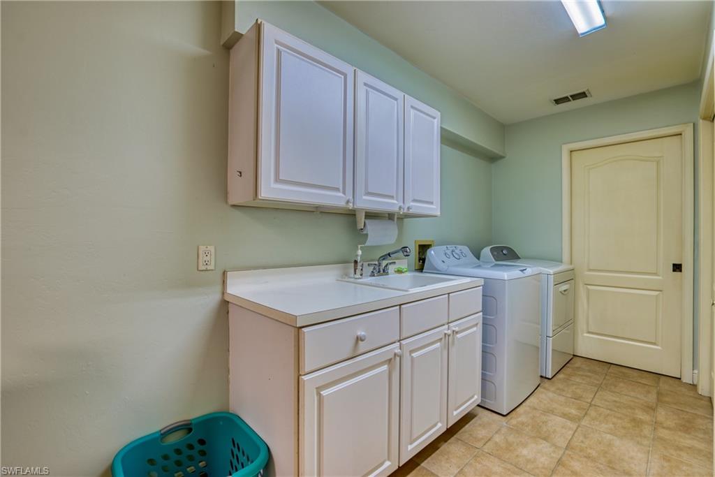 Laundry room featuring cabinet space and independent washer and dryer