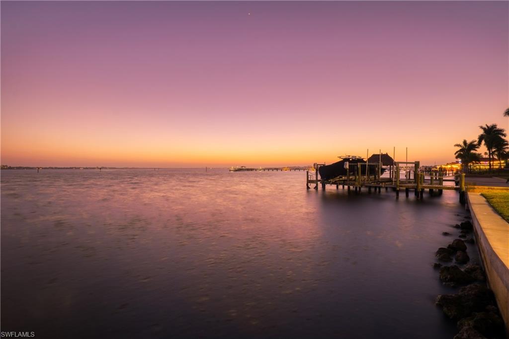 Water view with boat lift and a dock