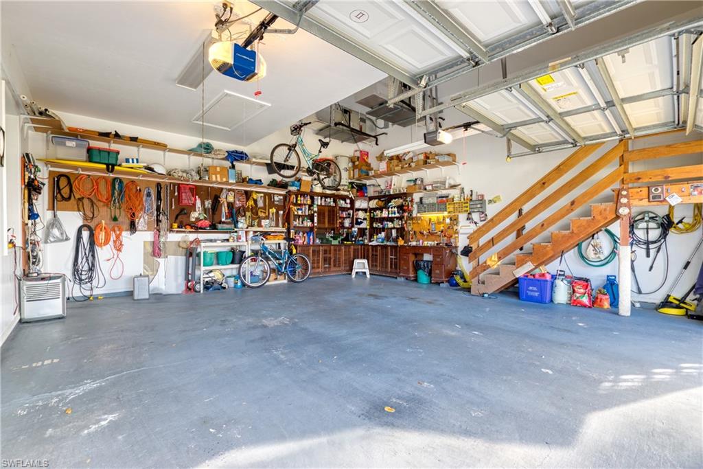 Garage featuring a workshop area and a garage door opener