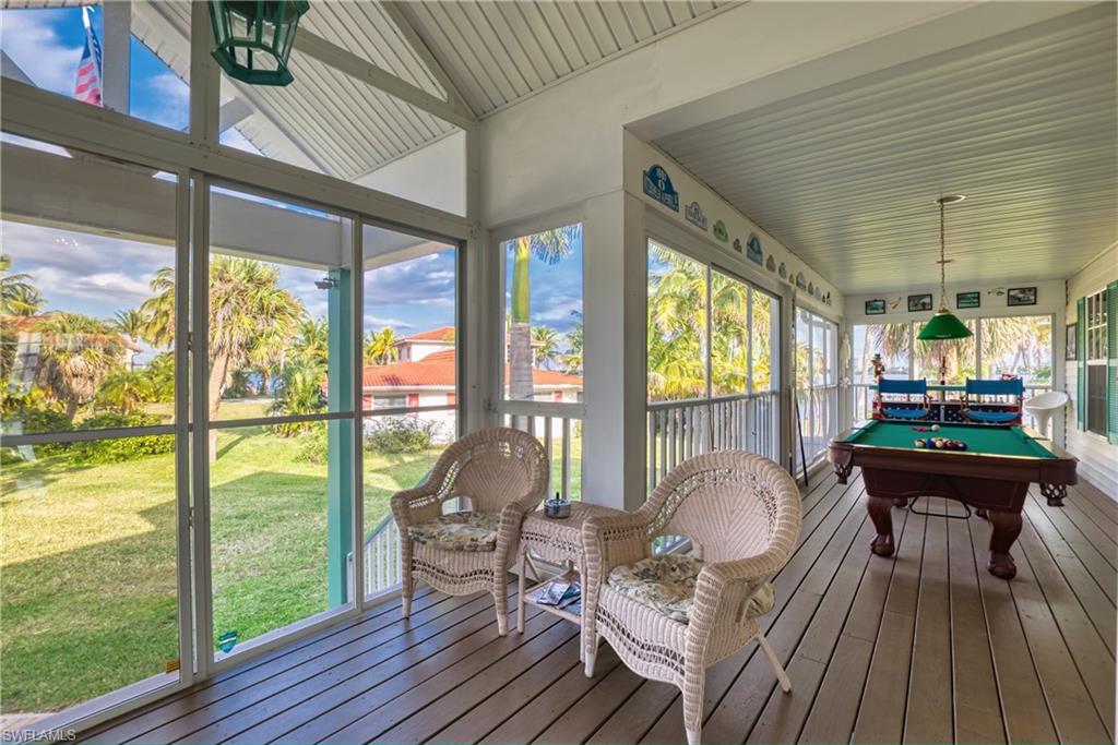 Sunroom / solarium featuring hardwood / wood-style floors, pool table, and a wooden deck