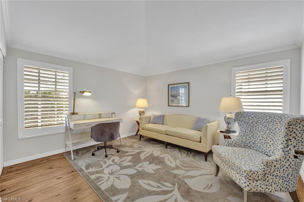 Office area featuring crown molding and light hardwood / wood-style flooring