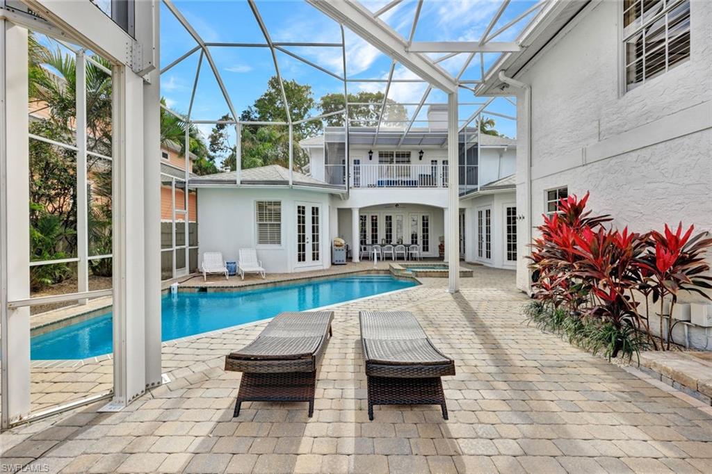 View of swimming pool with french doors and a patio