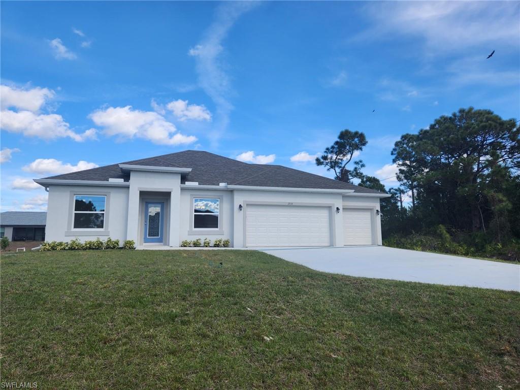 View of front of house featuring concrete driveway, a front yard, an attached garage, roof with shingles, and stucco siding