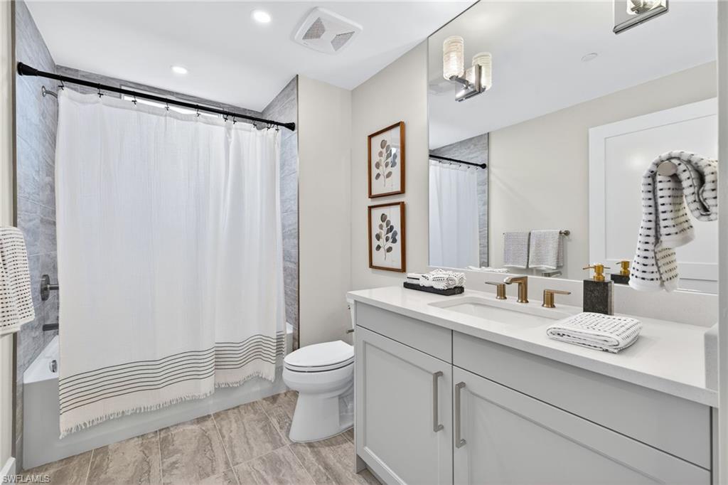 Bathroom 3 Full bathroom featuring shower / bath combo with shower curtain, vanity, and recessed lighting