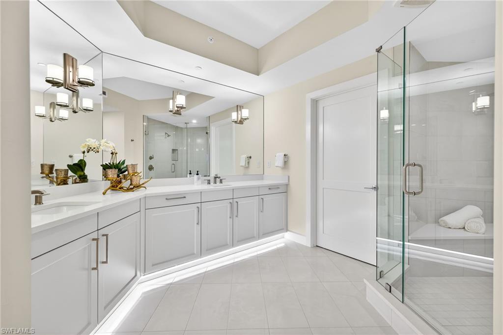 Master Suite Bathroom with a stall shower, double vanity, and light tile patterned floors