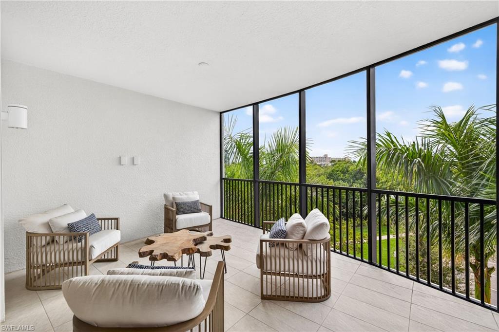 Bright sky views, native trees and flowers are seen from the large screened in terrace