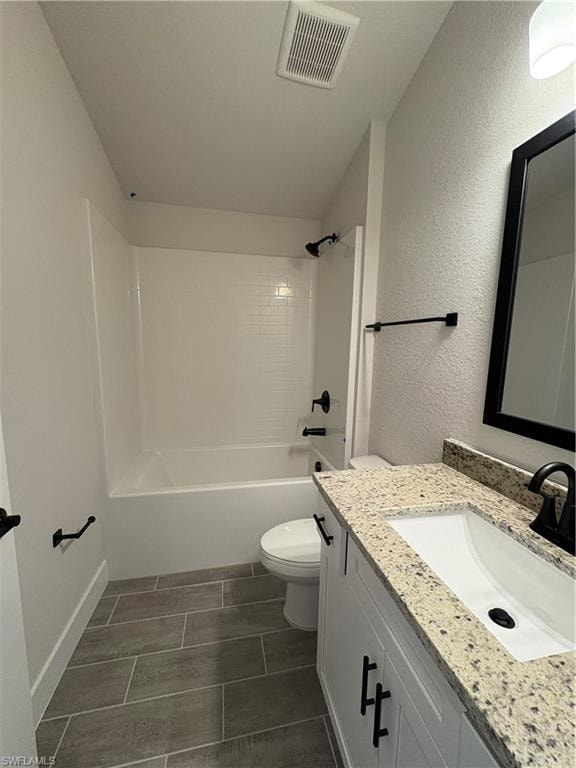 Full bathroom with vanity, shower / tub combination, and a textured wall