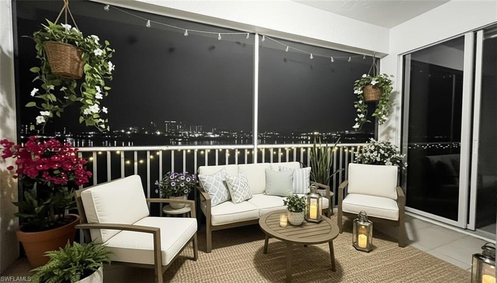 Balcony at night featuring an outdoor living space and a sunroom