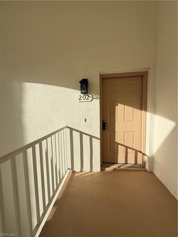 Entrance to property featuring stucco siding