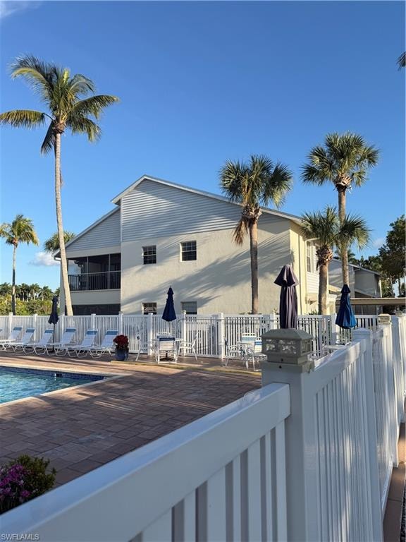 Back of property with a community pool