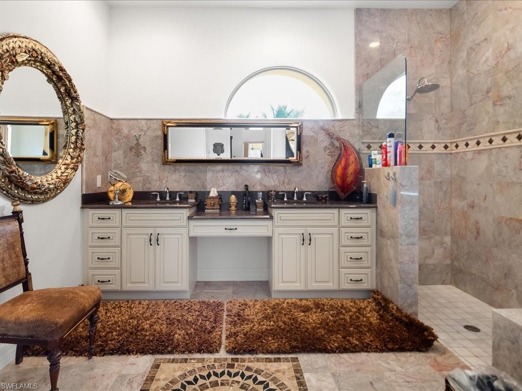 Full bath featuring a walk in shower and double vanity