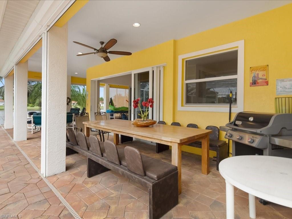 View of patio / terrace featuring outdoor dining area, a ceiling fan, and area for grilling