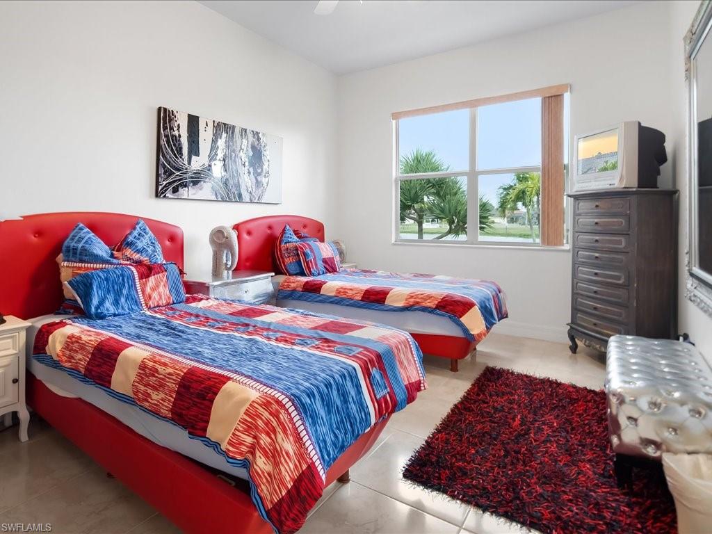 Bedroom with a ceiling fan and light tile patterned floors