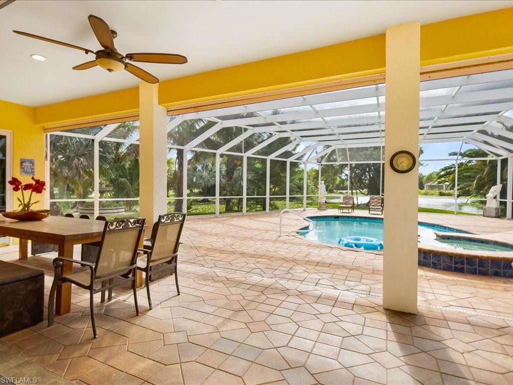 View of swimming pool featuring a patio, a sunroom, a lanai, and a pool with connected hot tub