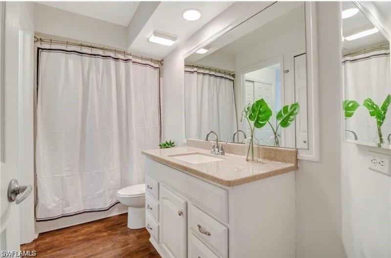 Bathroom featuring dark wood finished floors and vanity