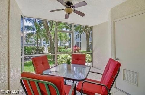Sunroom featuring a ceiling fan and outdoor dining space