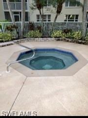 View of pool with a hot tub and a patio area
