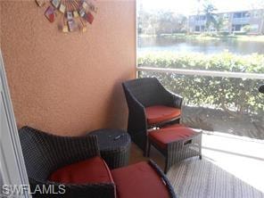 Sunroom featuring a water view and a tanning bed