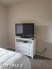 Bedroom featuring baseboards and carpet