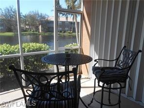 Sunroom featuring a water view