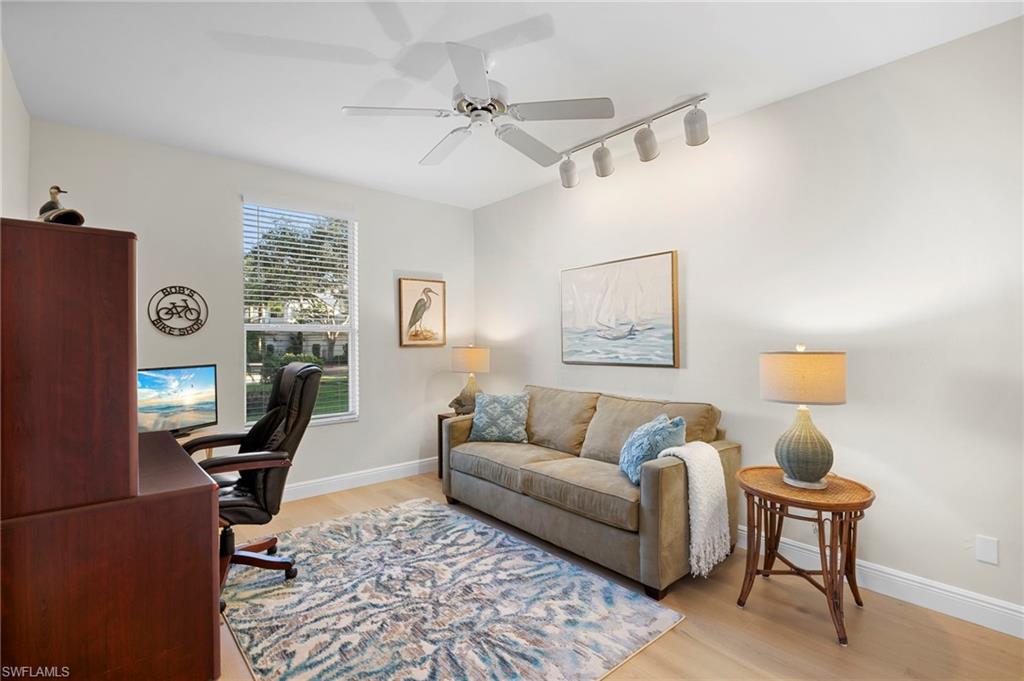Office featuring Mirage wood floors, rail lighting, and a ceiling fan