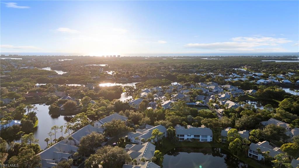 Aerial view of property and surrounding area with a large body of water