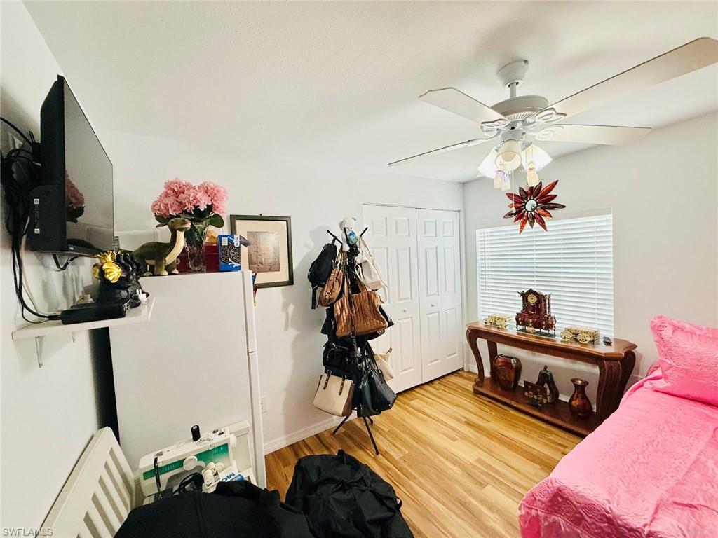 Bedroom featuring light wood-style floors, a closet, and ceiling fan