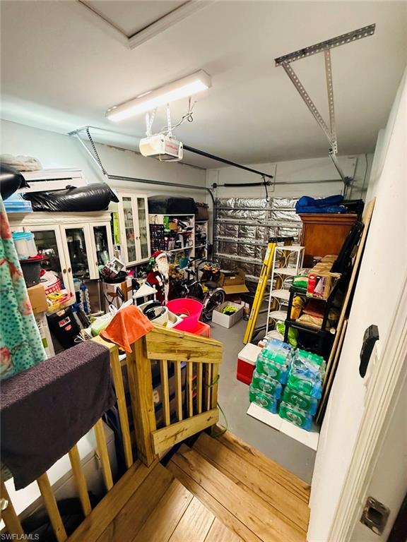Garage featuring a garage door opener and french doors