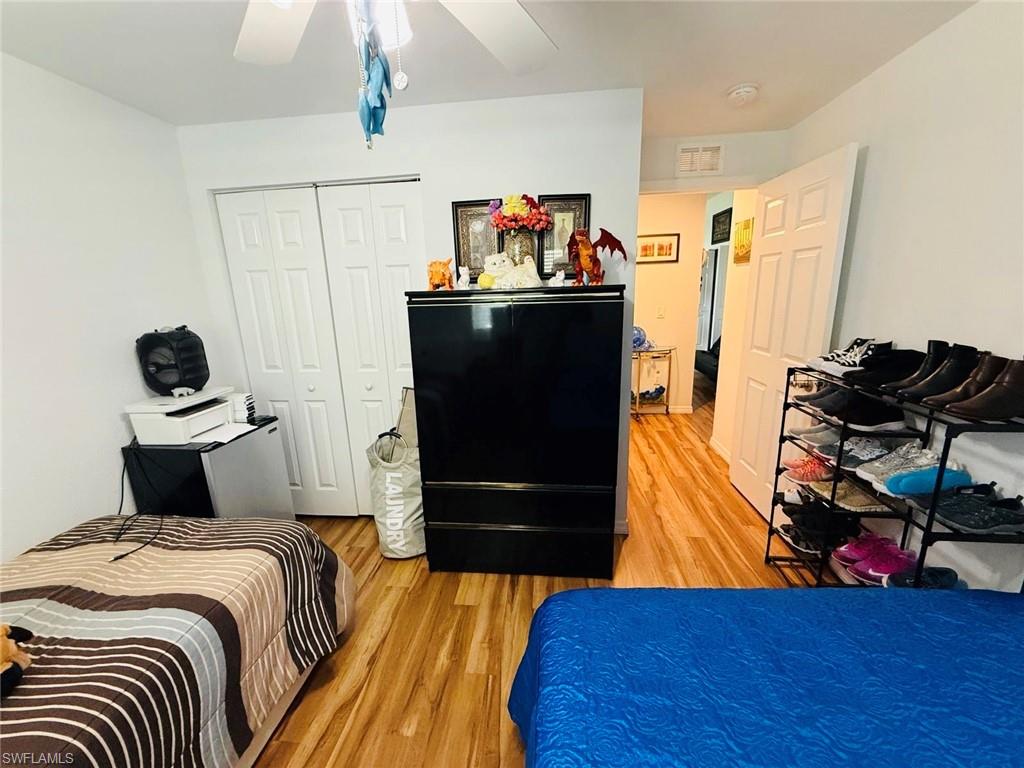 Bedroom featuring light wood-type flooring, a closet, and ceiling fan