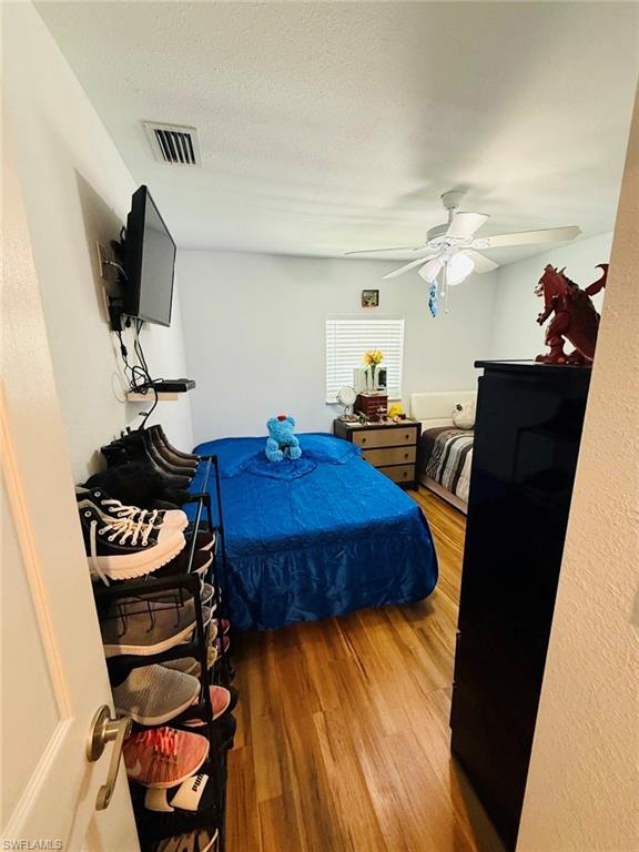 Bedroom featuring wood finished floors and ceiling fan