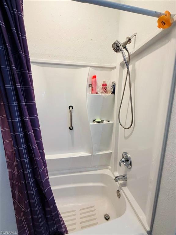 Full bath featuring shower / bathtub combination with curtain