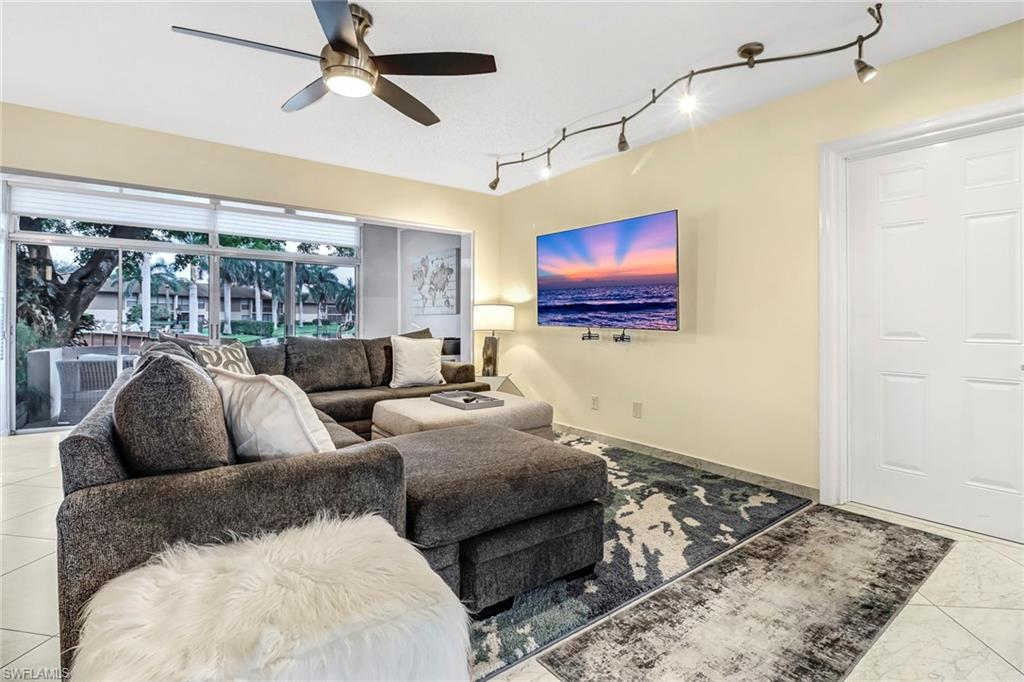 Living area with track lighting and ceiling fan