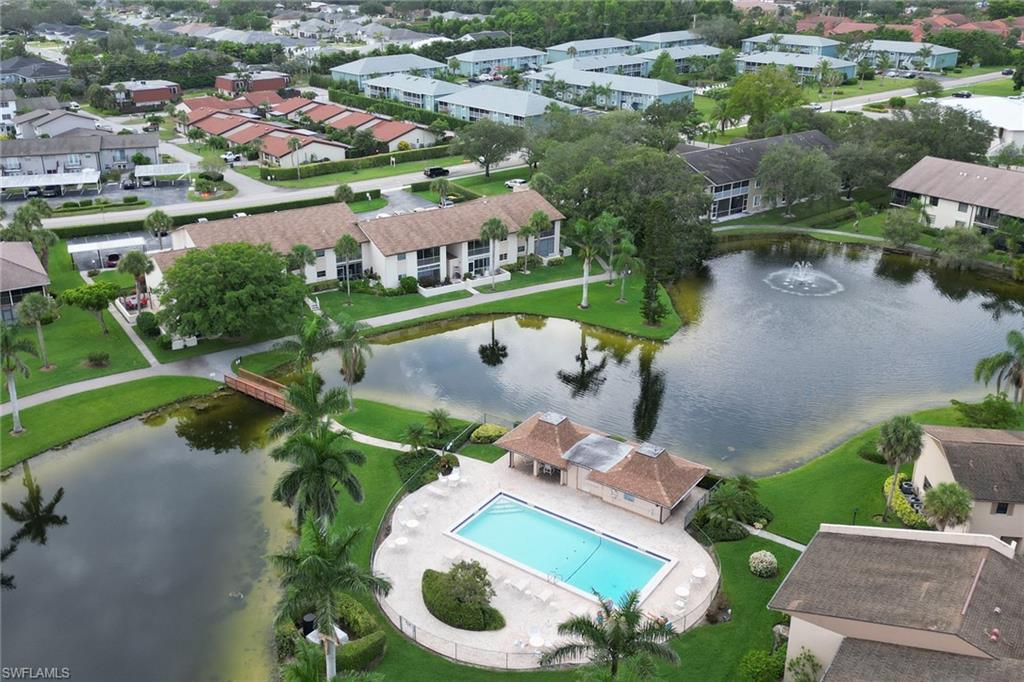 Aerial view of residential area with a large body of water and a pool area