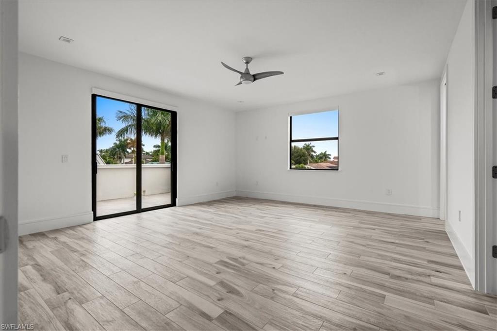 Empty room featuring light wood finished floors and a ceiling fan