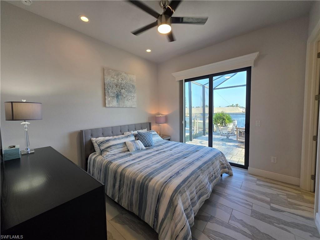 Bedroom featuring access to outside, a ceiling fan, recessed lighting, and a water view