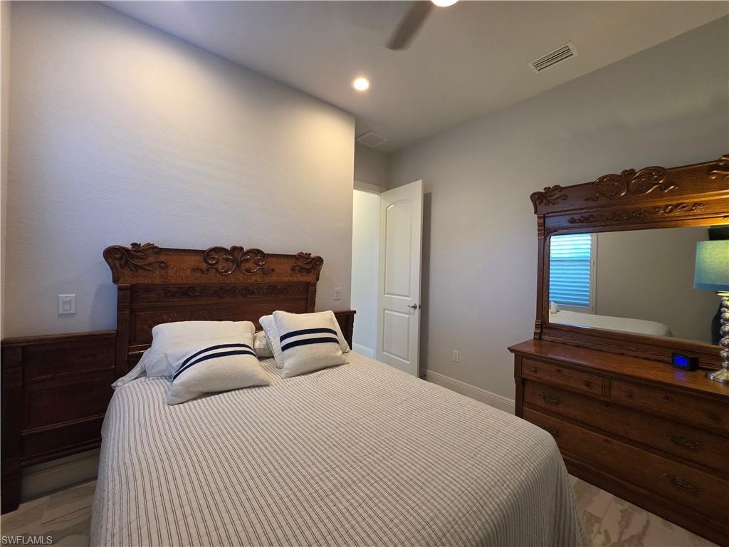 Bedroom with ceiling fan and recessed lighting