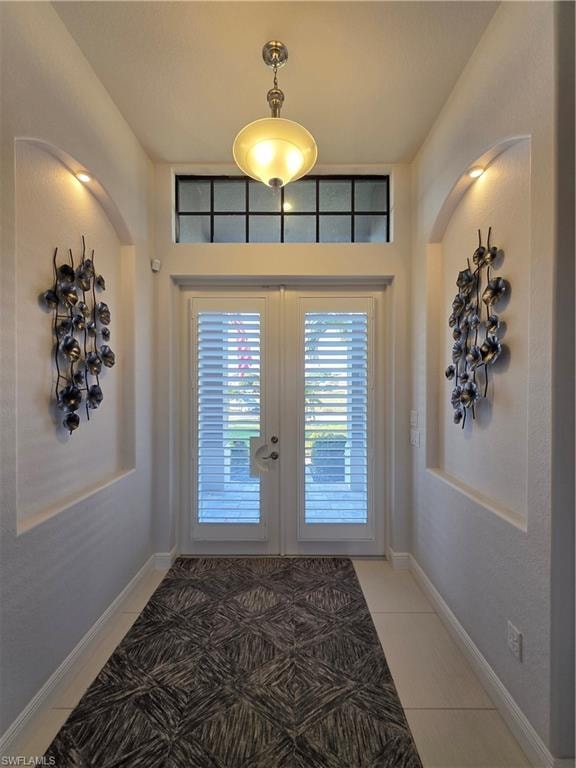 Doorway to outside featuring french doors and tile patterned floors