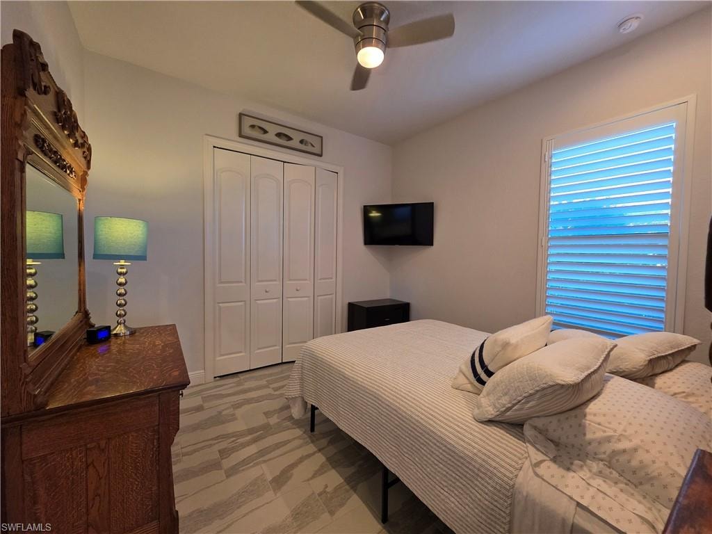 Bedroom with a closet and a ceiling fan