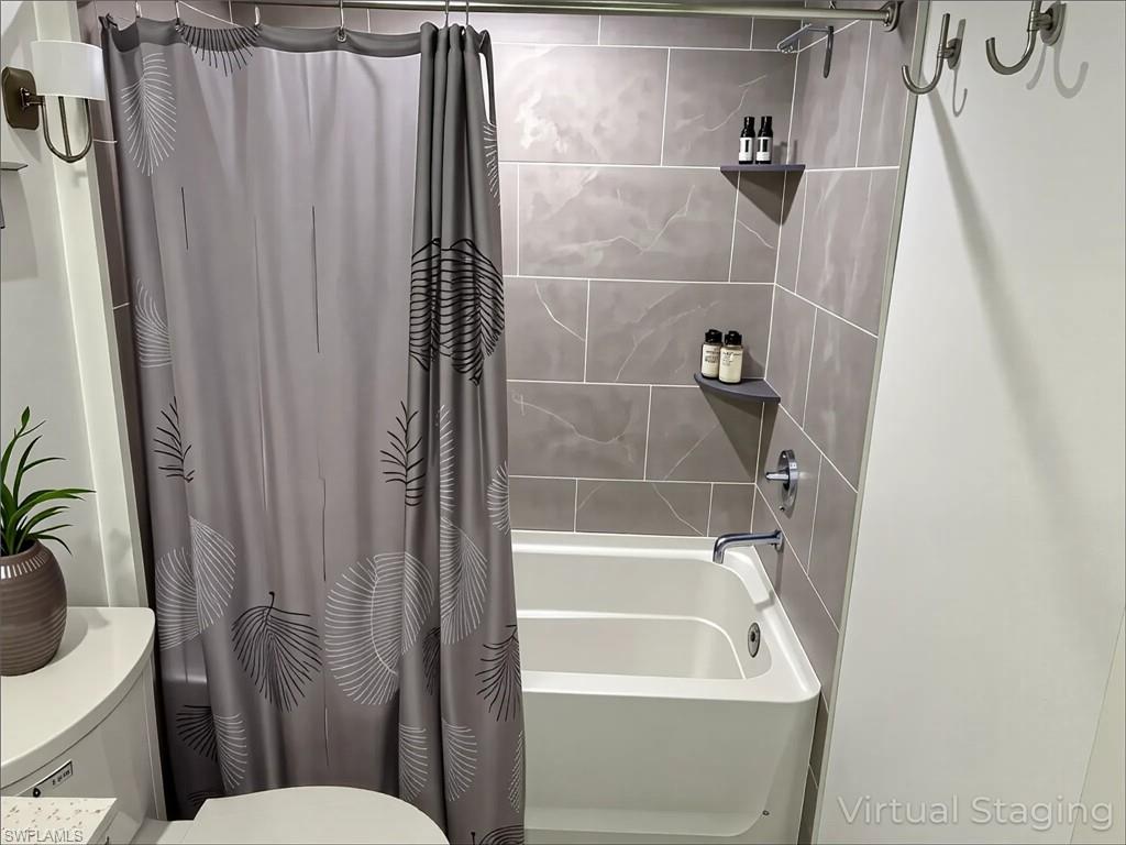 Full bath with shower / tub combo with curtain and toilet