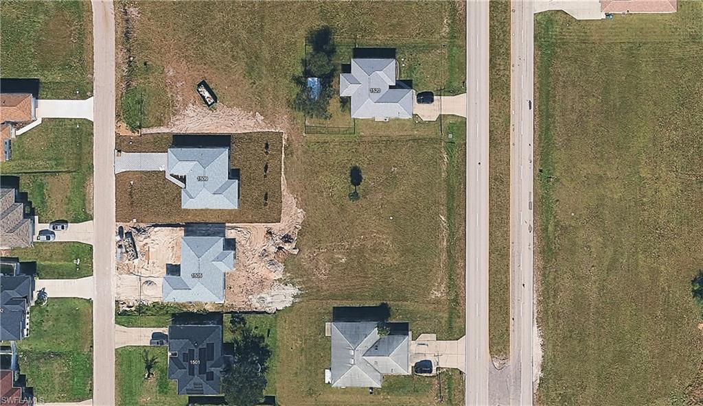 Aerial view of property's location with nearby suburban area