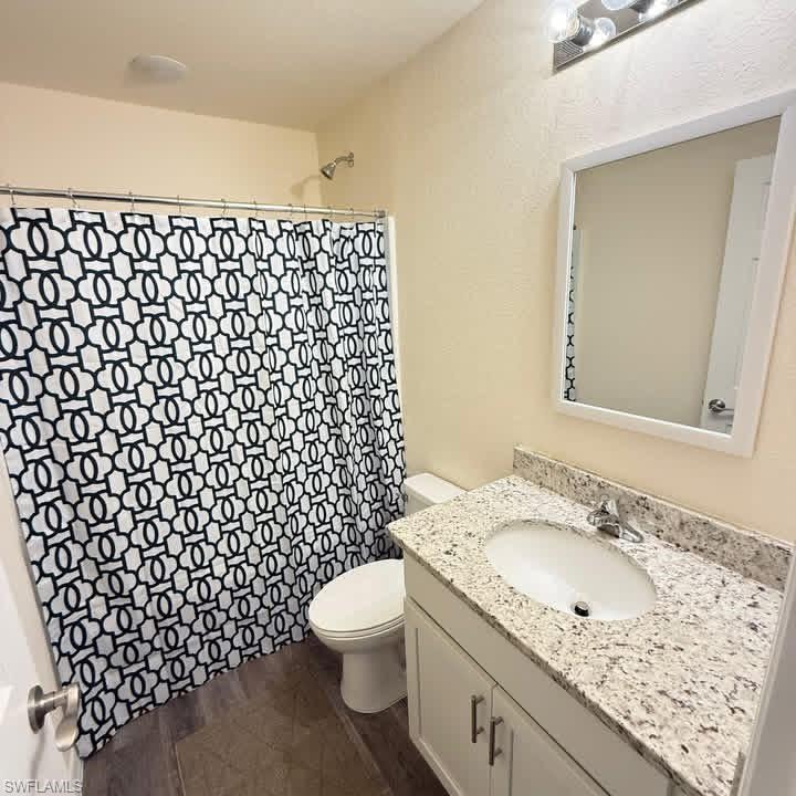 Full bathroom with vanity and curtained shower